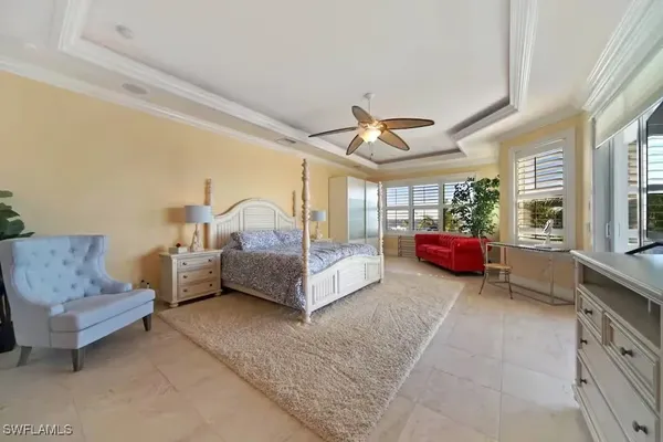 a spacious bedroom with a bed and a couch