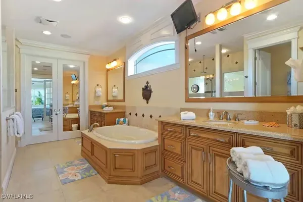 a spacious bathroom with a sink a toilet and mirror