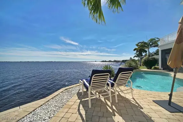 a backyard of a house with table and chairs