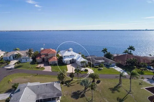 an aerial view of a house with outdoor seating
