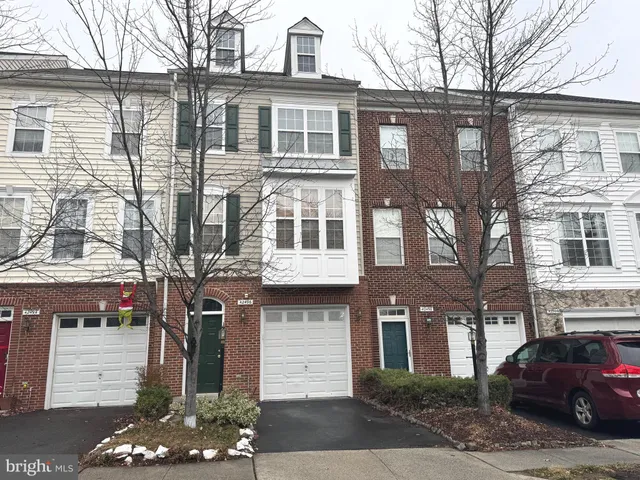 a front view of a residential apartment building with a yard