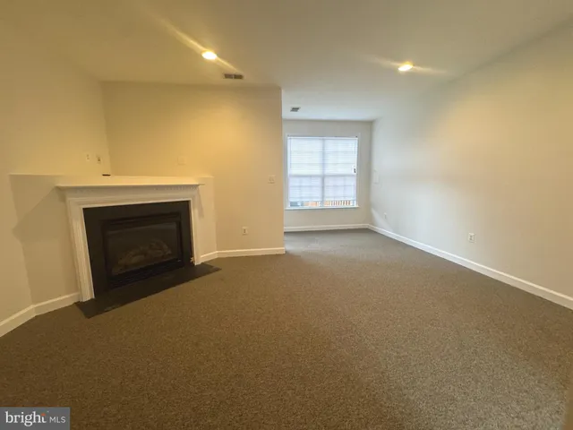 a view of empty room with a fireplace