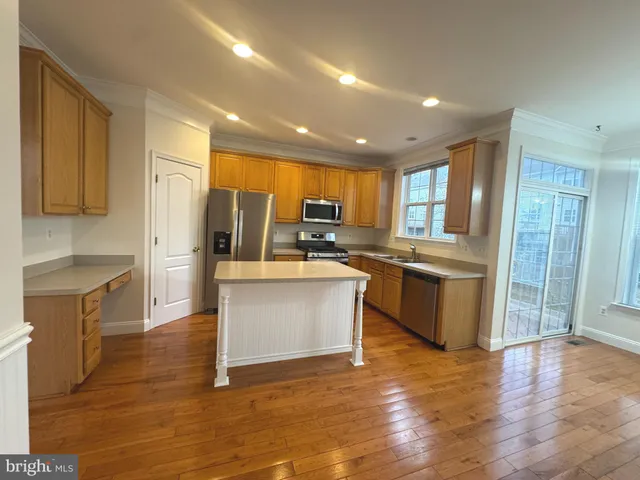 a kitchen with a refrigerator and a stove top oven