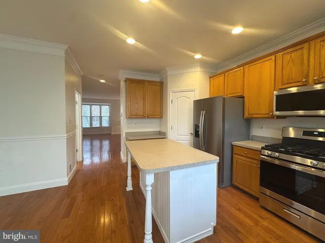 a kitchen with stainless steel appliances granite countertop a refrigerator a stove top oven a sink and dishwasher