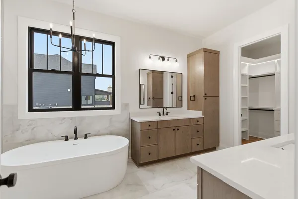 a bathroom with a bathtub sink and mirror