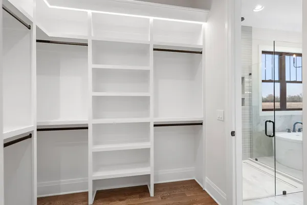 a view of walk in closet with empty racks