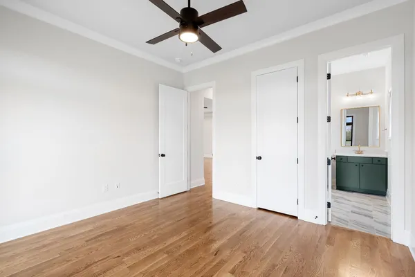a view of a hallway with wooden floor and staircase