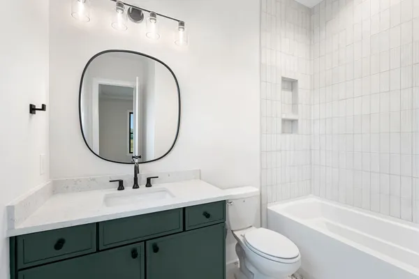 a bathroom with a sink a toilet and a mirror