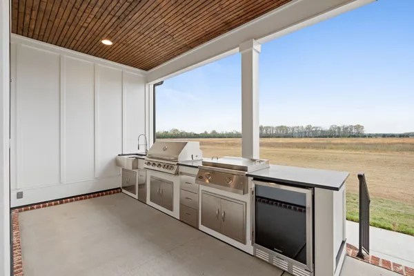 a open kitchen with stainless steel appliances granite countertop a stove and a refrigerator