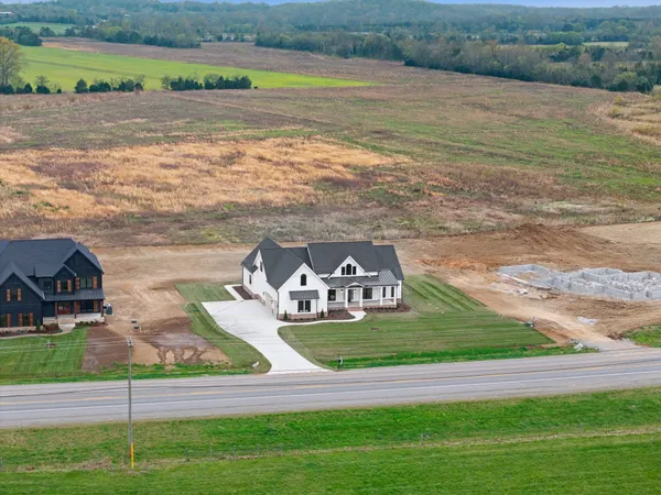 an aerial view of a house with big yard