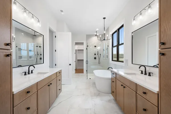 a spacious bathroom with a double vanity sink mirror double and bathtub