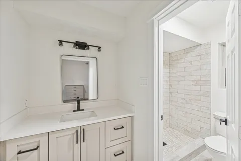 a bathroom with a toilet sink and shower