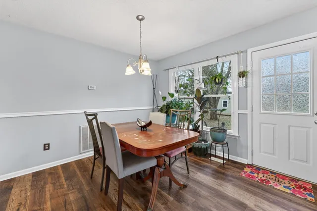 a bathroom with a granite countertop sink a mirror a vanity and shower