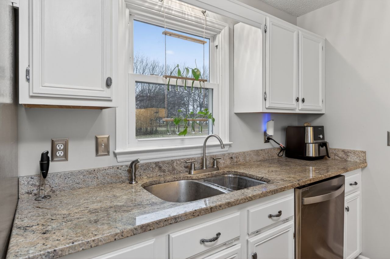 3740 Nicklaus Way Murfreesboro, TN 37128 - Photo 14 of 48 a kitchen with granite countertop a sink window and cabinets