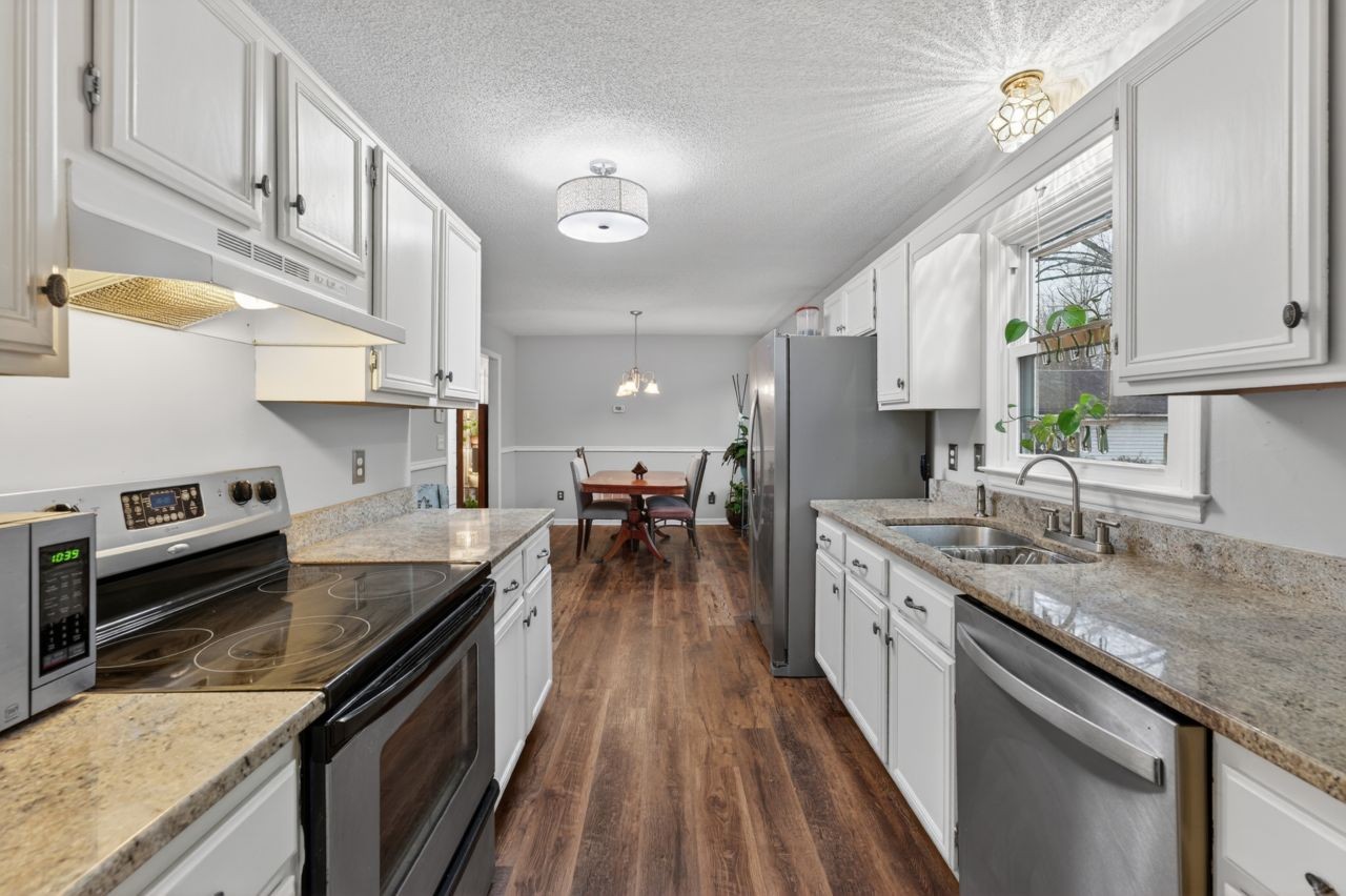 3740 Nicklaus Way Murfreesboro, TN 37128 - Photo 16 of 48 a kitchen with stainless steel appliances granite countertop a lot of counter space and wooden floors