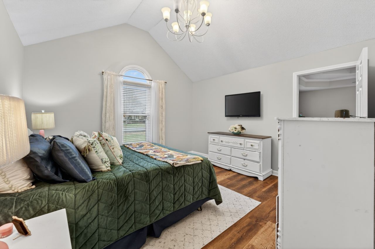 3740 Nicklaus Way Murfreesboro, TN 37128 - Photo 27 of 48 a bedroom with a bed a window and a flat screen tv