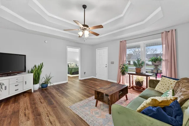 a dining room with furniture a chandelier and wooden floor