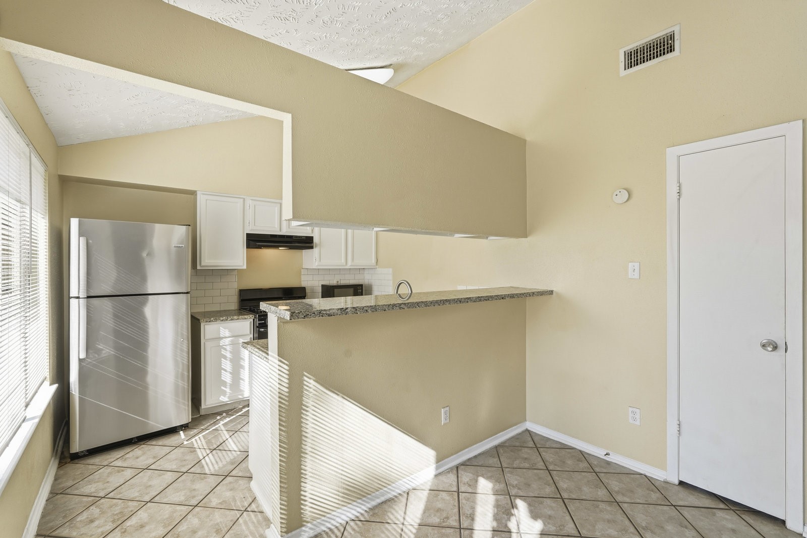 16235 Cutten Road Houston, TX 77070 - Photo 11 of 25 a kitchen with stainless steel appliances a refrigerator and a stove top oven