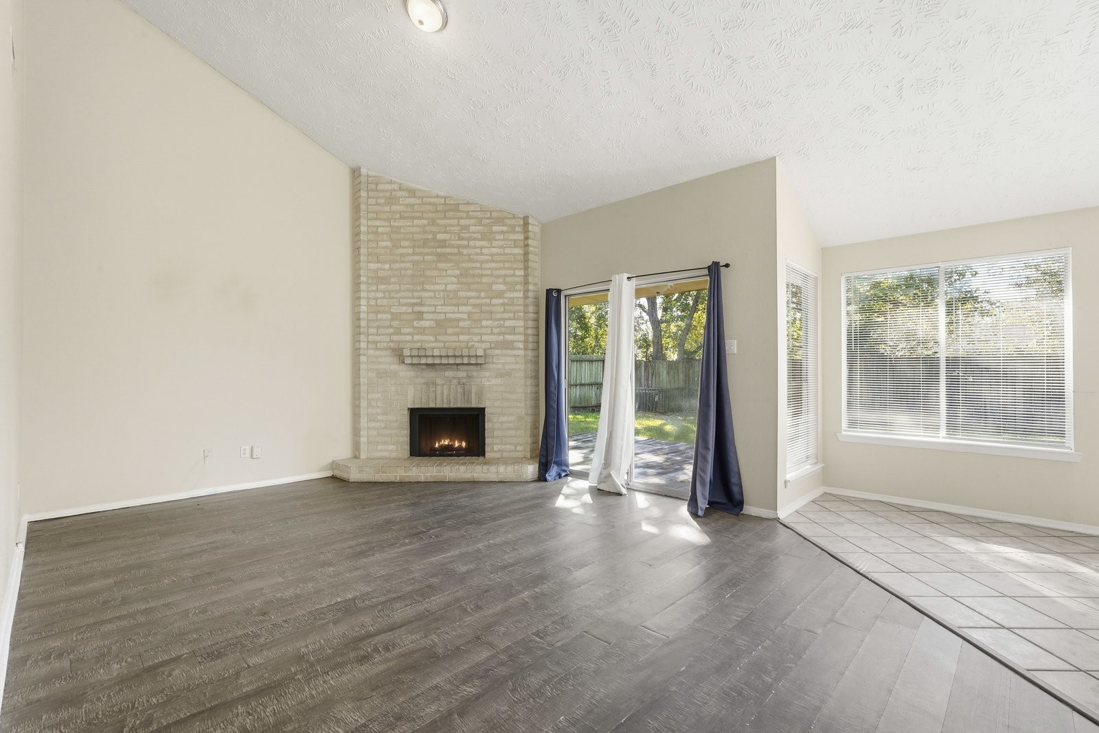 16235 Cutten Road Houston, TX 77070 - Photo 16 of 25 a view of an empty room with window and fire place