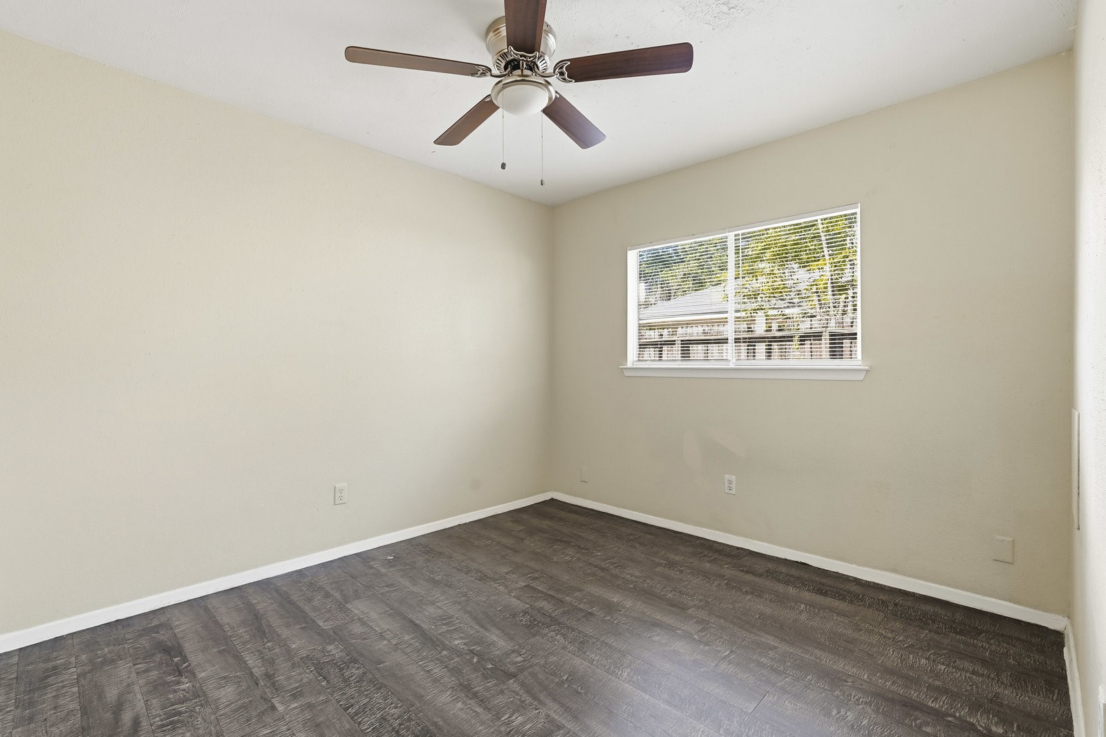 16235 Cutten Road Houston, TX 77070 - Photo 24 of 25 an empty room with a window and a fan