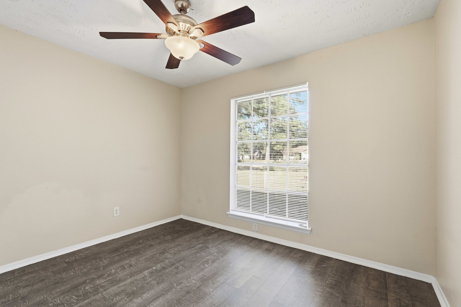 16235 Cutten Road Houston, TX 77070 - Photo 5 of 25 an empty room with wooden floor fan and windows