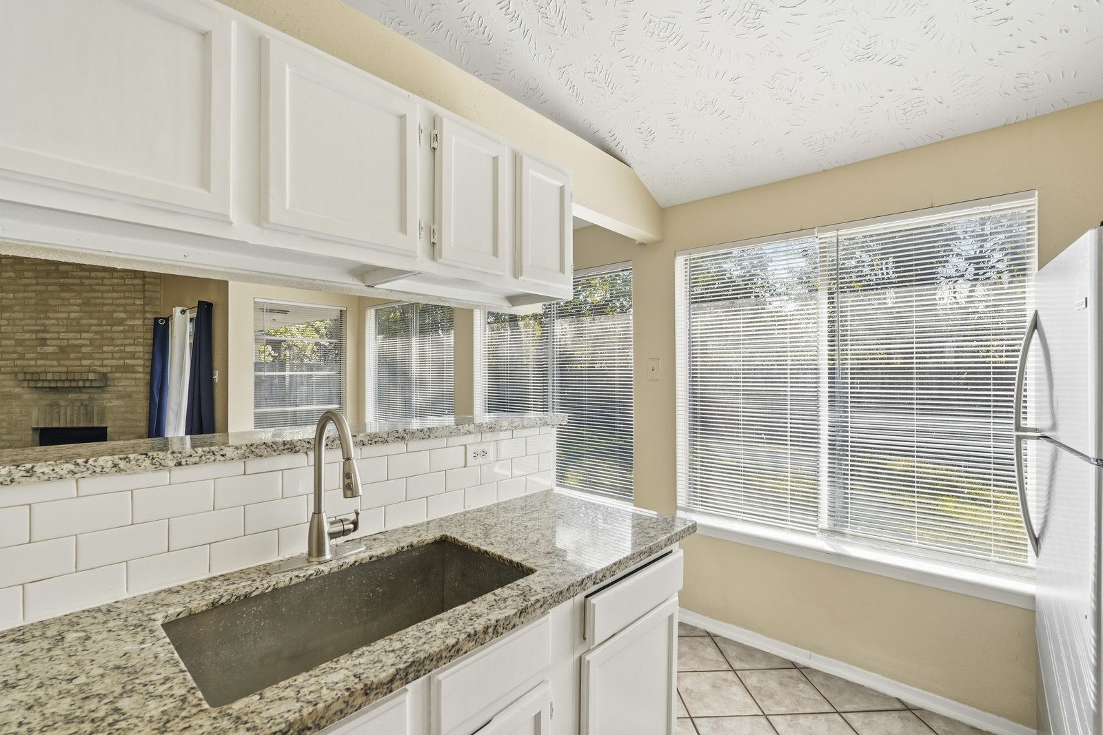16235 Cutten Road Houston, TX 77070 - Photo 9 of 25 a kitchen with granite countertop a sink and a stove