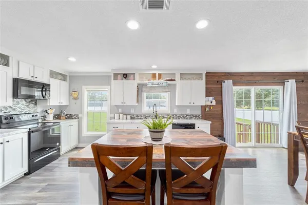 a view of a dining room with furniture window and outside view