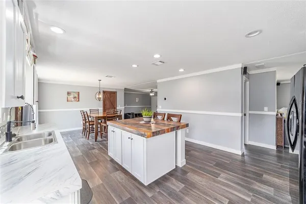 a open kitchen with stainless steel appliances granite countertop a stove and a wooden floors