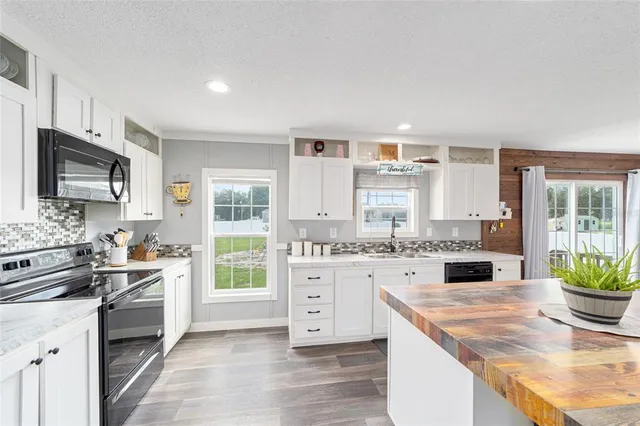 a kitchen with sink stove and cabinets