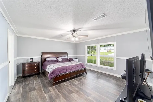 a bedroom with a bed and a large window