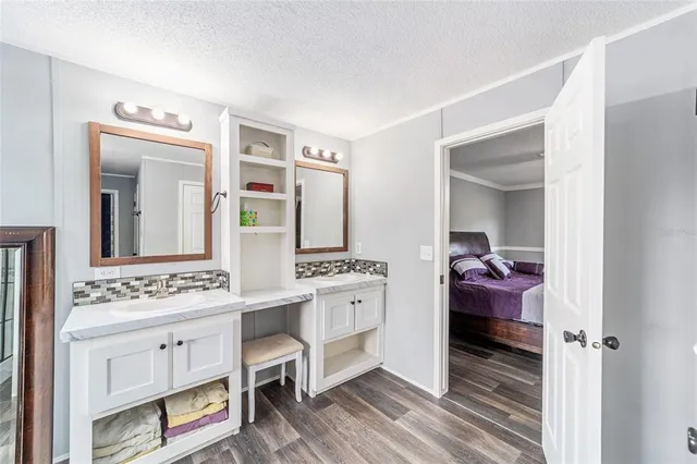 a en suite bathroom with a double vanity sink and a mirror
