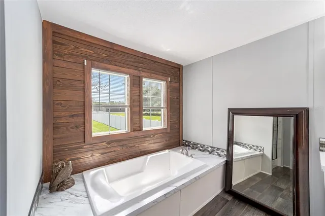 a spacious bathroom with a bathtub and a sink