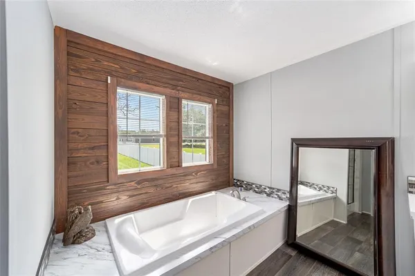 a spacious bathroom with a bathtub and a sink