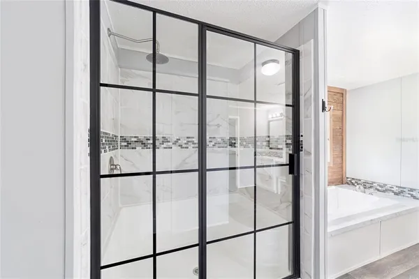 a bathroom with a glass shower door