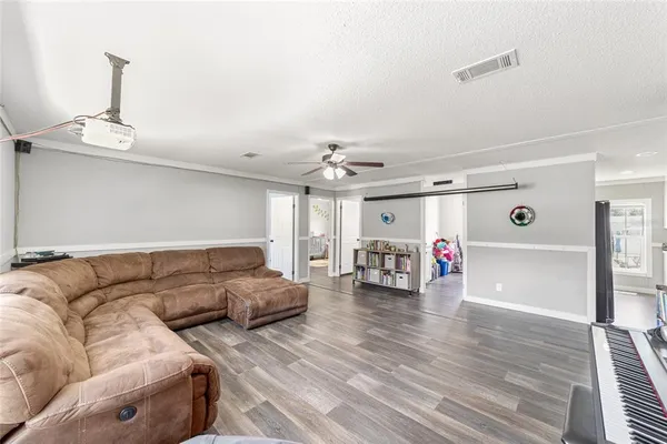 a living room with furniture and a chandelier