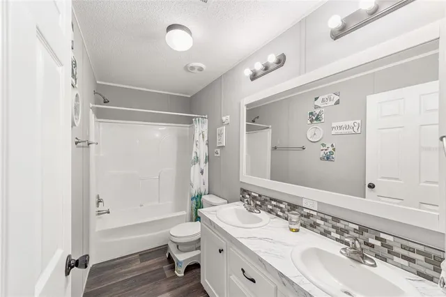 a bathroom with a double vanity sink mirror double and a shower