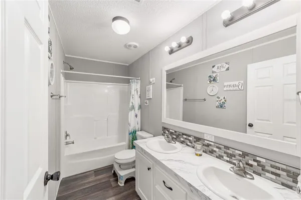 a bathroom with a double vanity sink mirror double and a shower