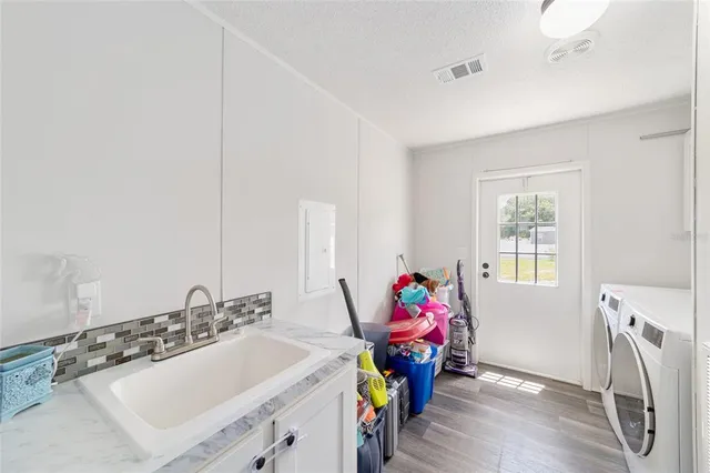 a bathroom with a sink mirror and a window