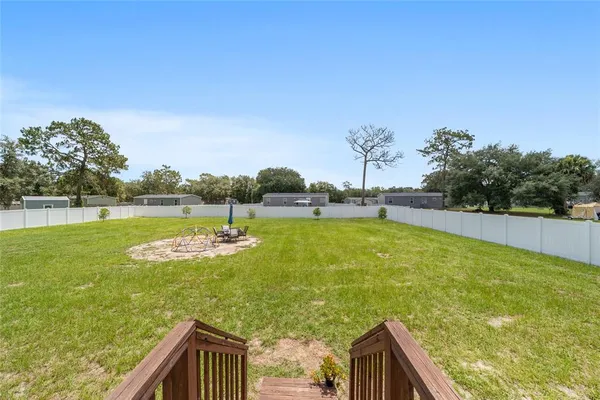 a view of a swimming pool with a garden and trees
