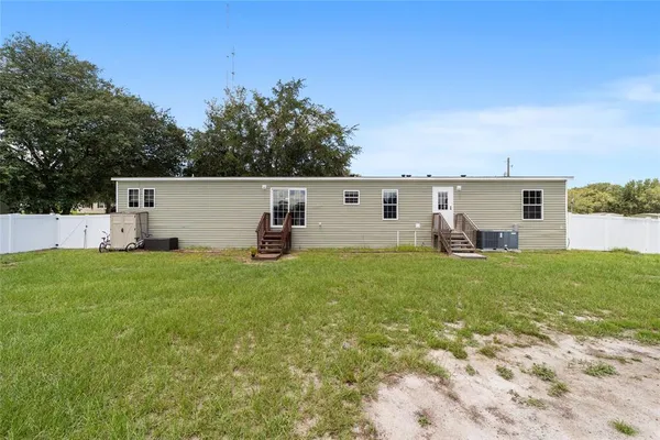 a view of a backyard with plants and a garden