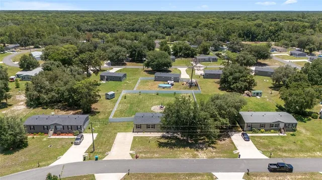 an aerial view of residential houses with outdoor space and street view