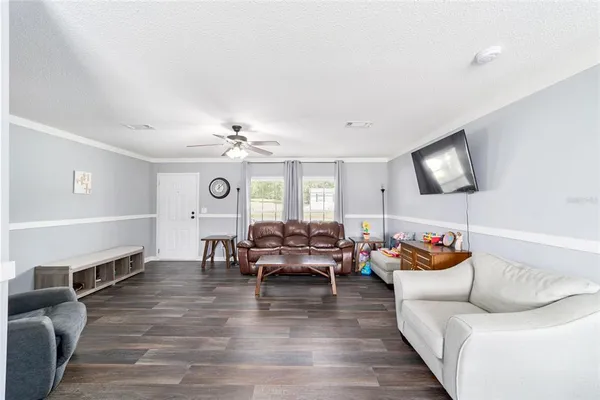 a living room with furniture and a chandelier