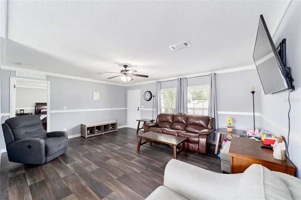 a living room with furniture and a wooden floor