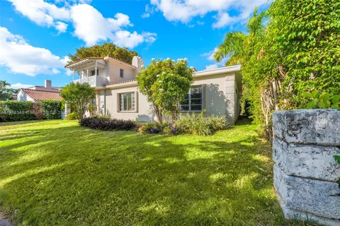 a view of backyard of house with green space
