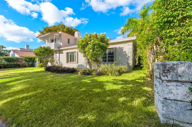 a view of backyard of house with green space