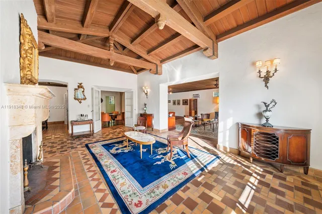 a living room with furniture a dining table and chairs with wooden floor