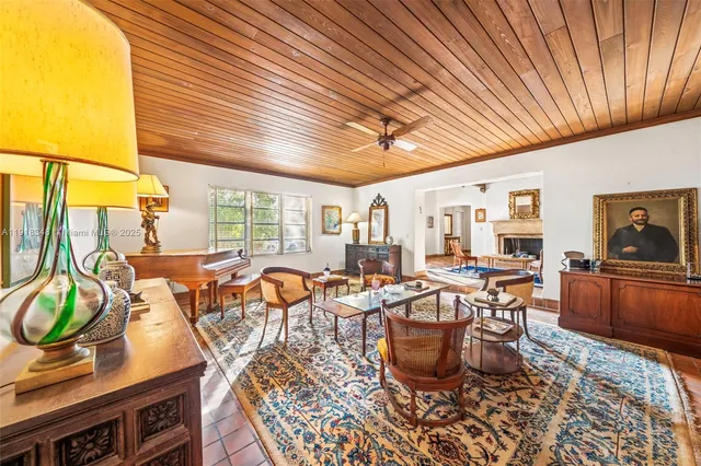a living room with furniture a rug and a potted plant