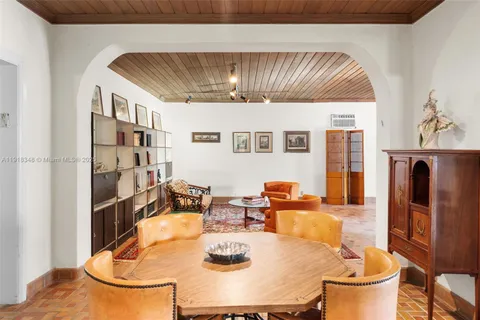 a dining room with furniture a window and wooden floor