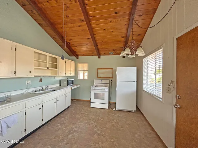 a kitchen with refrigerator and window