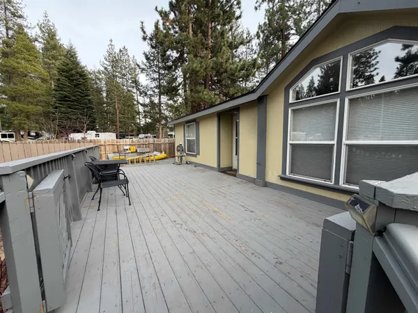 a kitchen with a table chairs refrigerator and wooden cabinets